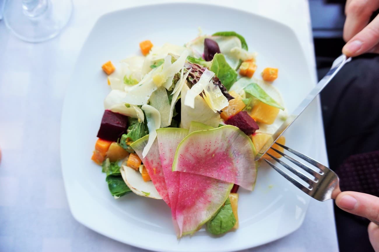 Seasonal salad with shaved watermelon radish, roasted beets, squash and shaved cheese